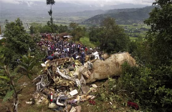 Nepalese rescue workers and civilians gather around the wreckage of a Beechcraft 1900D operated by Buddha Air after it crashed in the mountains outside Bisankunarayan village, just south of Katmandu, Nepal, early Sunday.